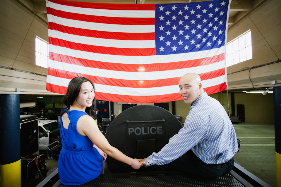 police officer, swat member, swat vehicle, armored vehicle, wedding couple, engaged couple in front of swat vehicle, san francisco swat, american flag, police, couple on top of swat car