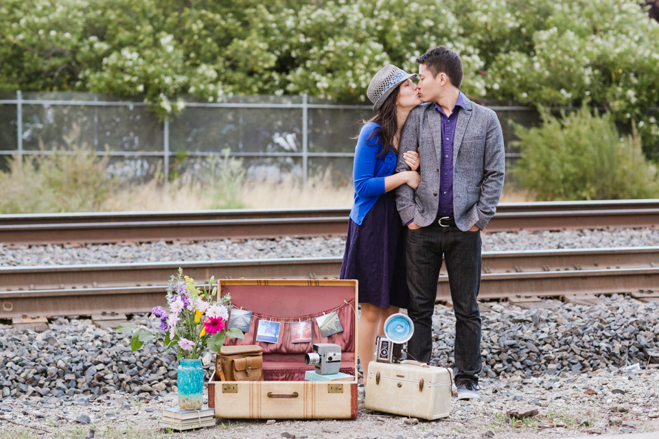 train station engagement session, vintage engagement session, vintage luggage, vintage cameras, vintage polaroids, sports theme engagement session, large soccer beach ball, basketball, creative engagement photography, burlingame caltrain