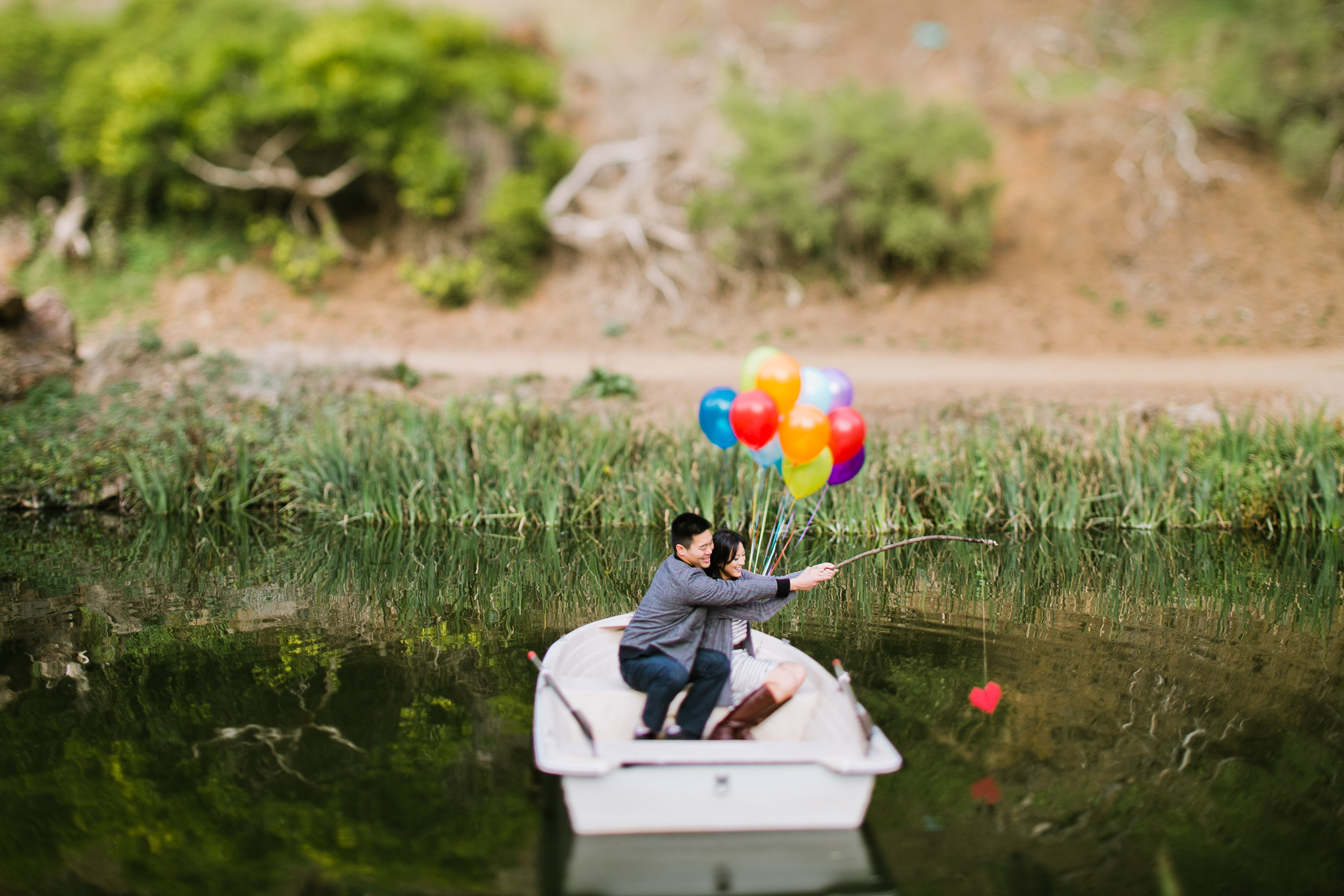 row boat engagement, bouquet of balloons, row boat, fishing rod with a heart, couple in a boat, san francisco engagement, bay area wedding photographer, jasmine lee photography